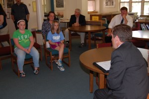 Commissioner Bowen asks questions of Jessica Burnell and Abby Chandler, two of the student panelists who helped describe their experiences with proficiency-based education at Gray-New Gloucester Middle School.