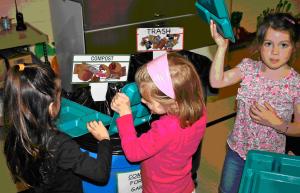 Kittery-Mitchell Horace Mitchell Primary kindergarten students (from left to right) Paeton Brown, Carolyn Carven and Olivia Kenney sort their trash as part of a student-driven recycling effort.