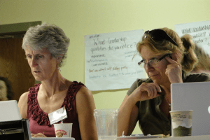Two art teachers share materials at the four-day Maine Arts Assessment Initiative institute in August.