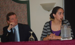 Commissioner Bowen listens as Monmouth Academy senior Adriana Ortiz-Burnham describes a typical day in her student-centered AP Biology class: one group of students listening to the teacher's lecture, one group working in the lab, and another taking a test.
