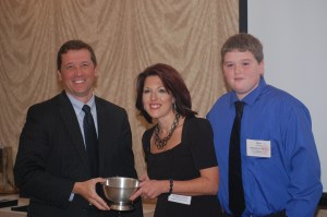 TOY Banquet Education Commissioner Stephen Bowen congratulates 2013 Teacher of the Year Shannon Shanning, pictured with a former student, at celebratory banquet.
