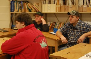 Students Lucas Eaton (black cap), Devon (green cap) and Dan Fill  speak with Commissioner Bowen.