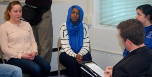 LHS students (from left to right) Paige Clabby, Amal Mohamed and Faith Ide describe their early college experiences to Commissioner Stephen Bowen.