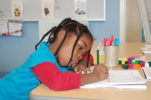 East End Community School kindergartner Christine Akilimali practices math word problems.