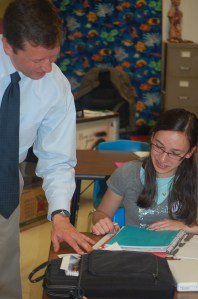 Mountain Valley Middle School student Abby LaBrash explains her genetics project to Commissioner Bowen.