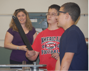 Students Anthony Whitman (left) and Austin Canning, of Oxford Hills MS, working on their racecar at Crazy Horse Racing.