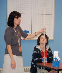 Biddeford Middle School student Breneg Howard listens as math lab coach Heidi Miller shows students how to measure the rebound of a bouncy ball.