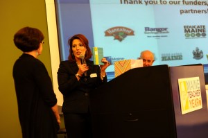 Outgoing 2013 Teacher of the Year Shannon Shanning gives advice and personal gifts including a journal to the 2014 honoree