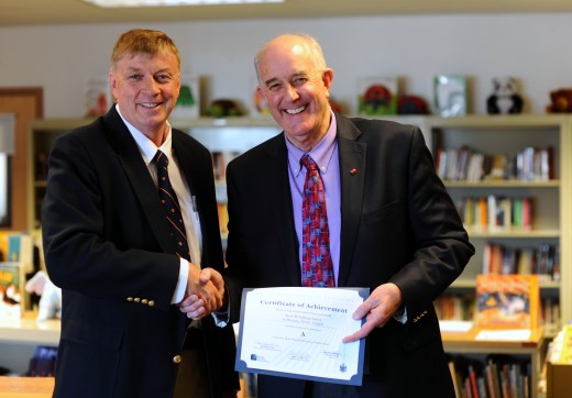 Maine Education Commissioner Jim Rier presents Rose M. Gaffney School Principal Mitchell Look with a certificate of achievement for earning an A on their 2014 school report card. The school received a C last year. 