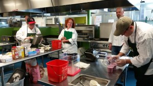 Judges looking on as Team Knox Rocks makes breakfast