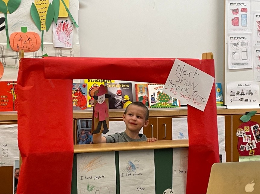 Pre-K students enjoy putting on a puppet show at snack time each day.