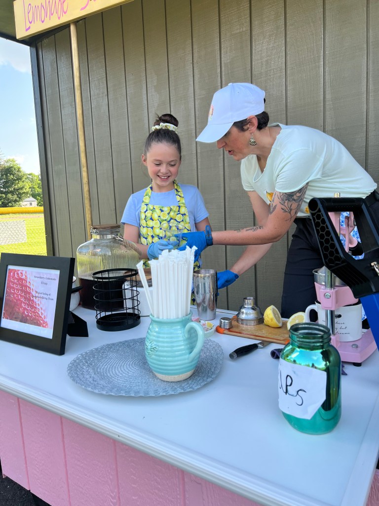 Amanda Baker and her daughter running a lemonade stand.