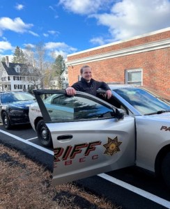 In this photo a new Mainer participates in a ride along and information interview with local law enforcement.