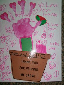 a student created picture of a hand coming out of a flower pot with hearts drawn everywhere