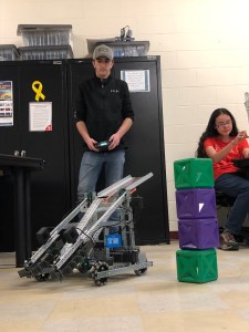 Dillon Foley and Victoria Lin working on the two team robots. The robot that is currently operational is designed to collect the blocks and carry them to a new location.