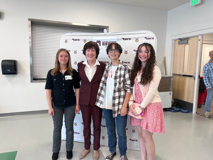 Students Katelynn Thibodeau, Liz Robbins and Sadielee Violette pose with Senator Susan Collins