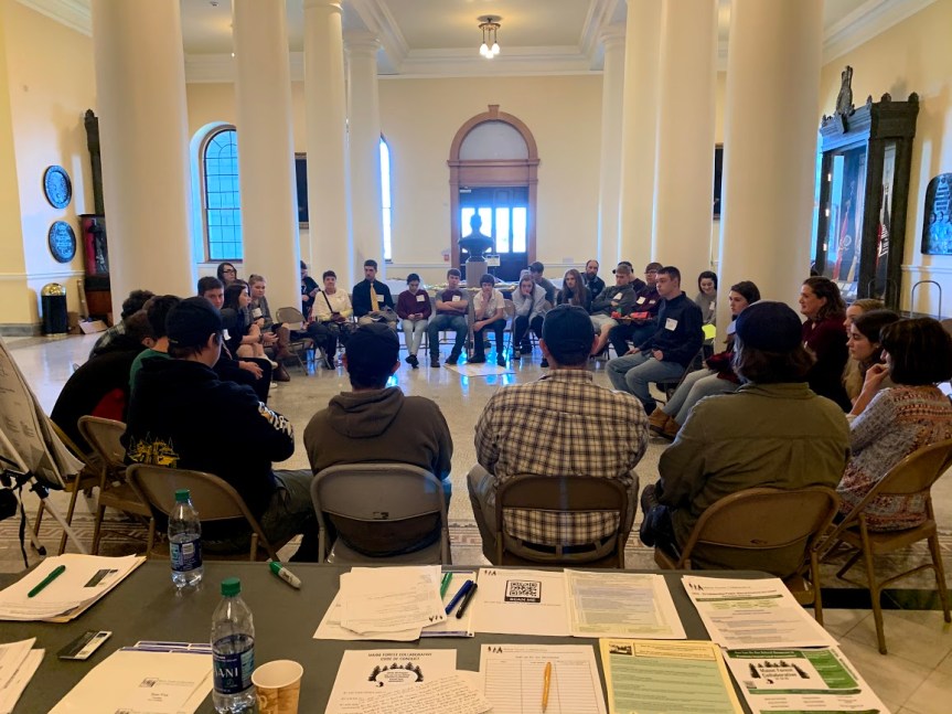 students sitting in a circle in the Hall of Flags