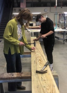 students working on a structure indoors