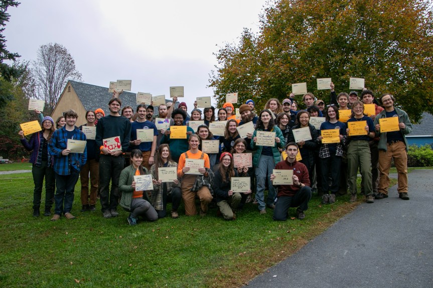 Maine AmeriCorps members holding the "I Serve" signs they filled out at the event.