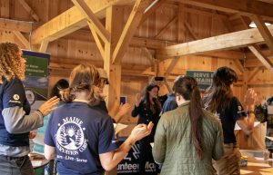Maine DOE Associate Commissioner Chelsey Fortin-Trimble swearing in Maine AmeriCorps members.