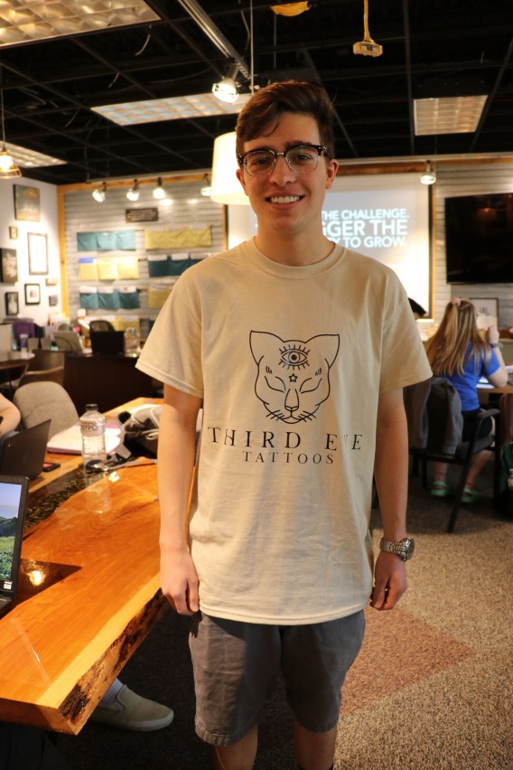 UTC student Josiah Brochu wearing a t-shirt bearing his self-designed logo