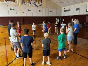 students circled up in gym
