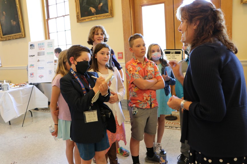 Students interviewing Commissioner Makin