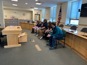 Laura Cyr leading students in a mock legislative hearing.