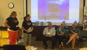 Educators presenting to other educators wearing shark hats
