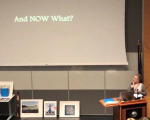 educator presenting with a big slide that reads, "And NOW What?"