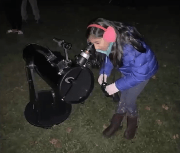 A Glenburn student looks through the telescope at the Star Party