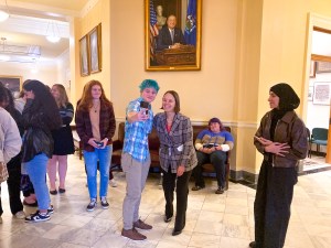 students taking photos with secretary bellows