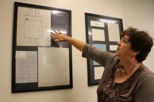 EUT staff member Cathy Severance points to a old hand-drawn floor map now on display at the EUT offices in Augusta.