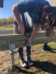student working on a structure outdoors