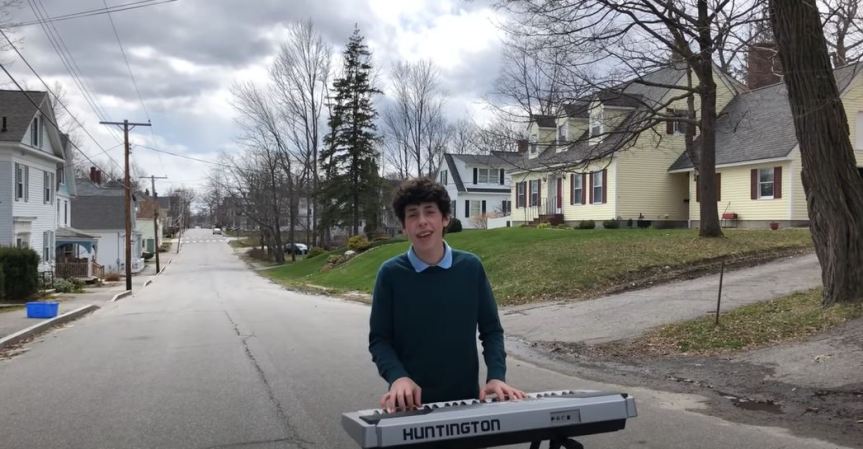 Isaac Ensel playing the keyboard in the street