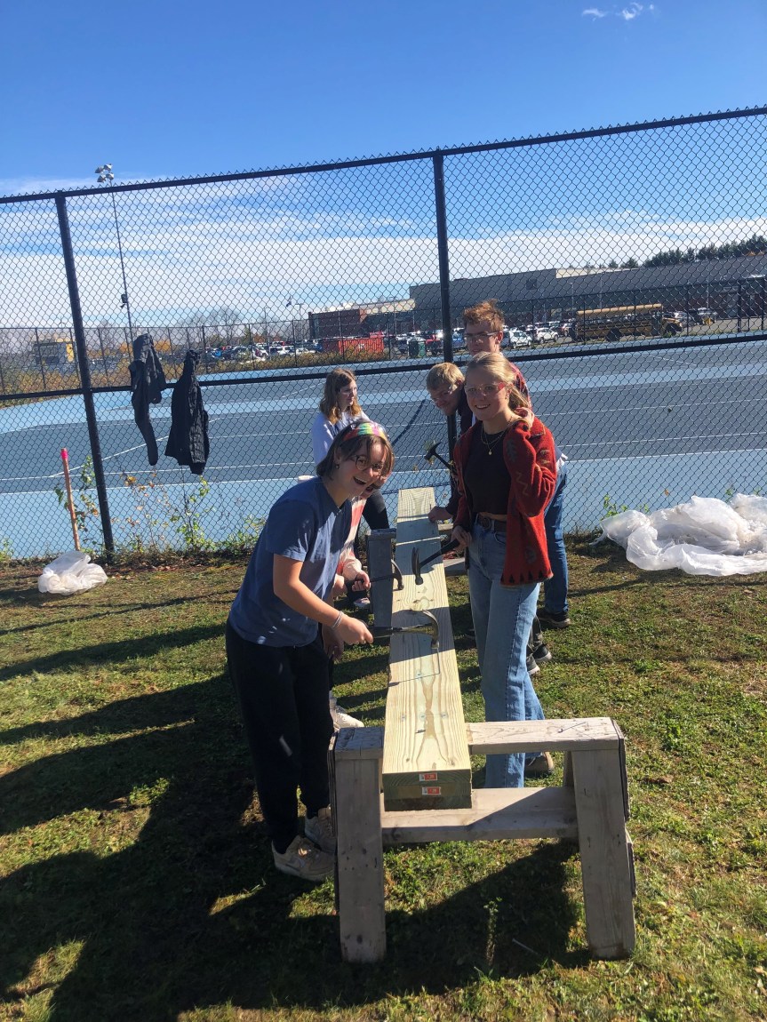 students working on a structure outdoors