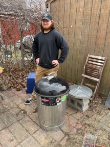 Malcom Gartland with the meat smoker he and Matthew Breece made for their senior capstone