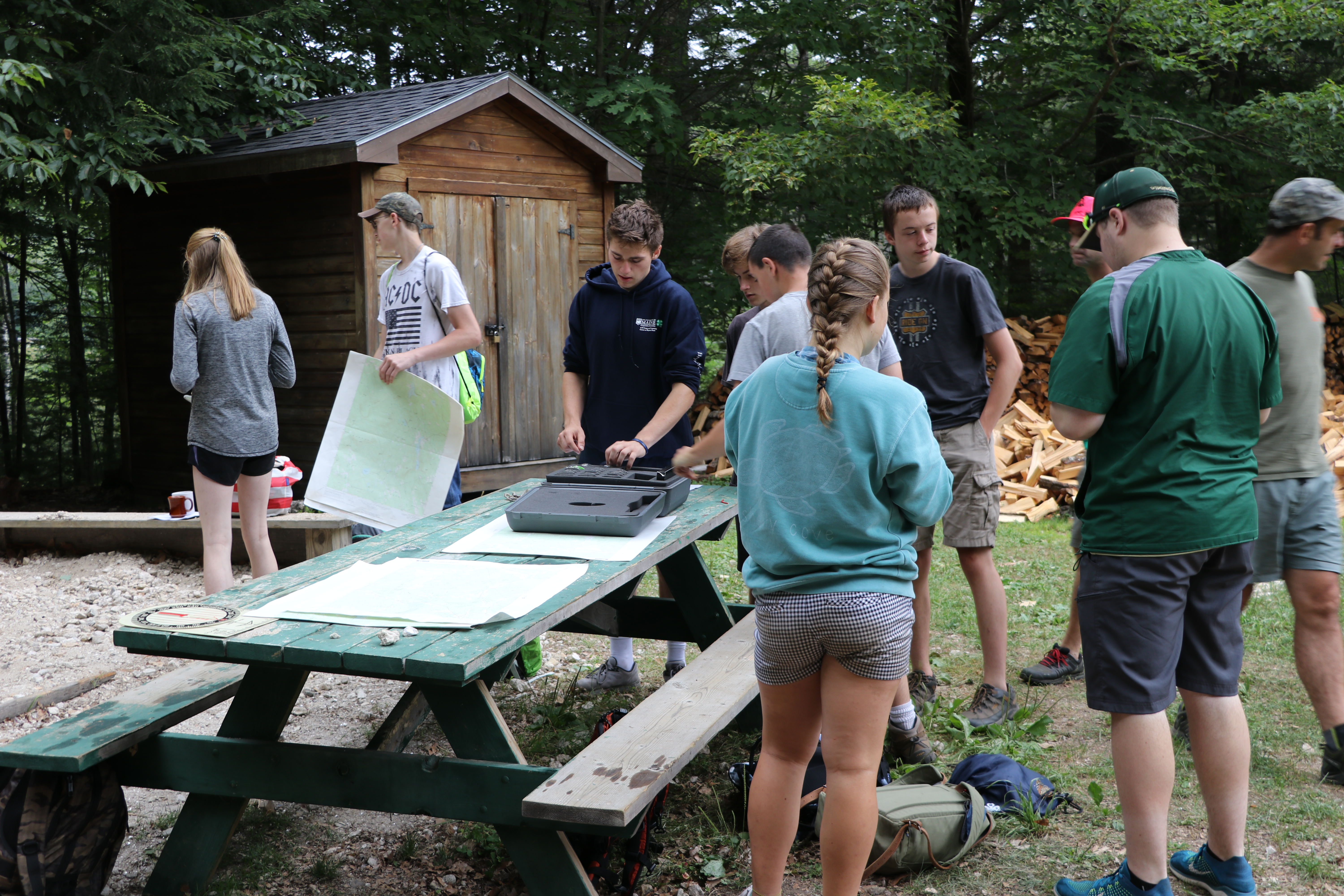Students retrieve compasses to be used in orienteering.