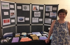 Educator standing in front of table display with pamphlets