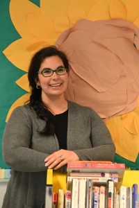 woman with dark hair in glasses smiling
