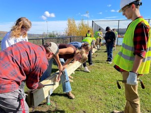 students working on a structure outdoors