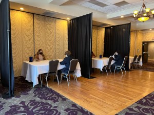 students seated facing each other at hotel conference room
