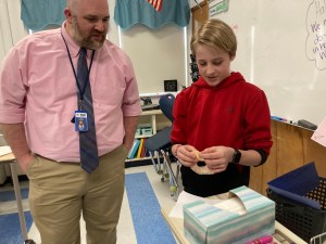 Principal Ward and a student at the Origami Connections Class
