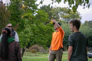 Harrison Lobb holding up the invasive species the volunteers were helping remove that day.