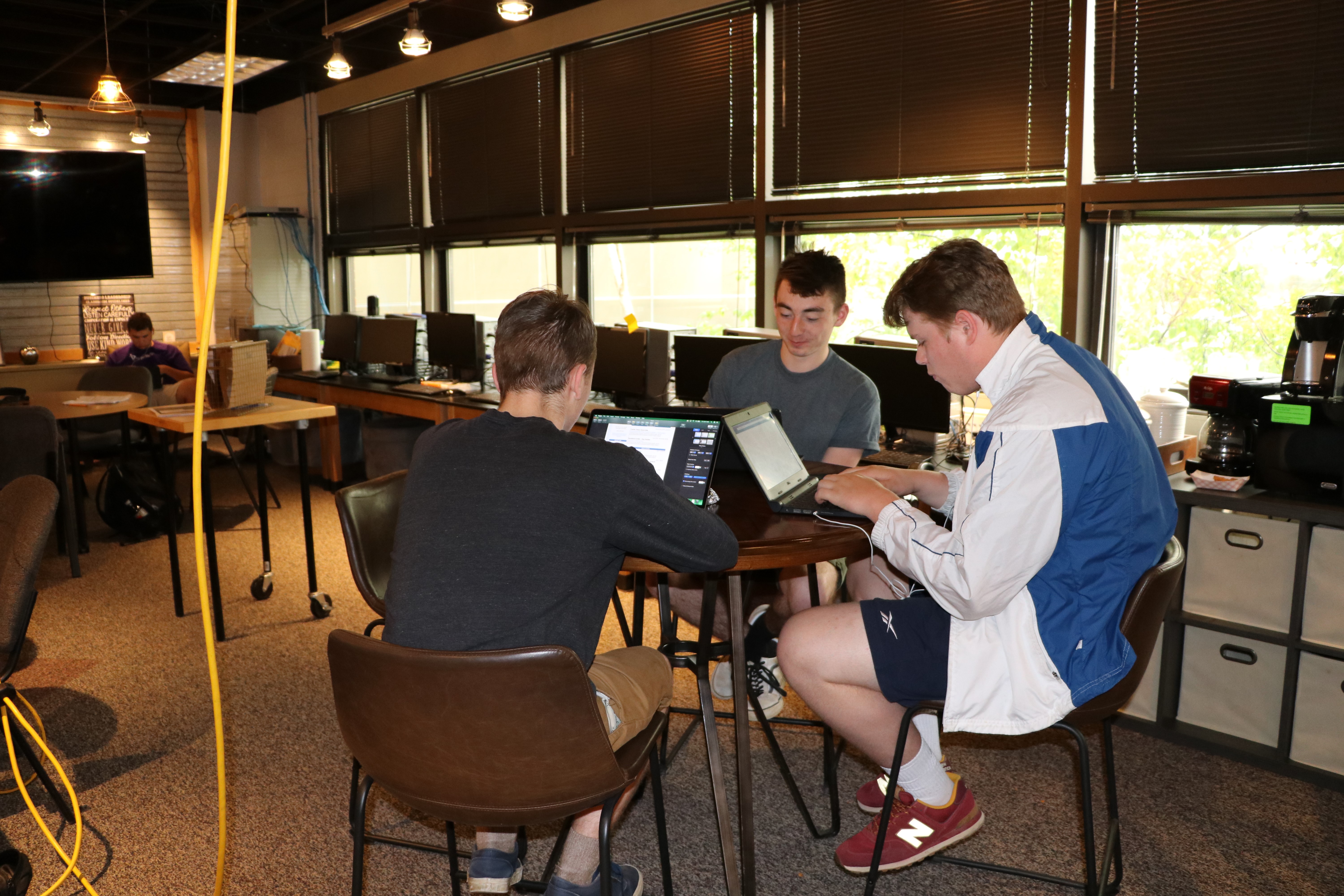 Left to Right: Dylaan Cannon, Taylor Tindall, and Levi Williamson working in the Technology room 