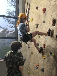 Gentile Hall Social Event – Students on Rock Wall, one of available activities