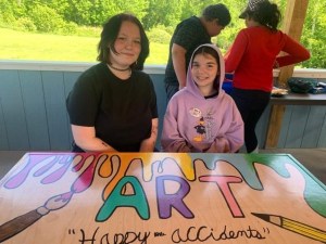 two students at a table with art painted on it