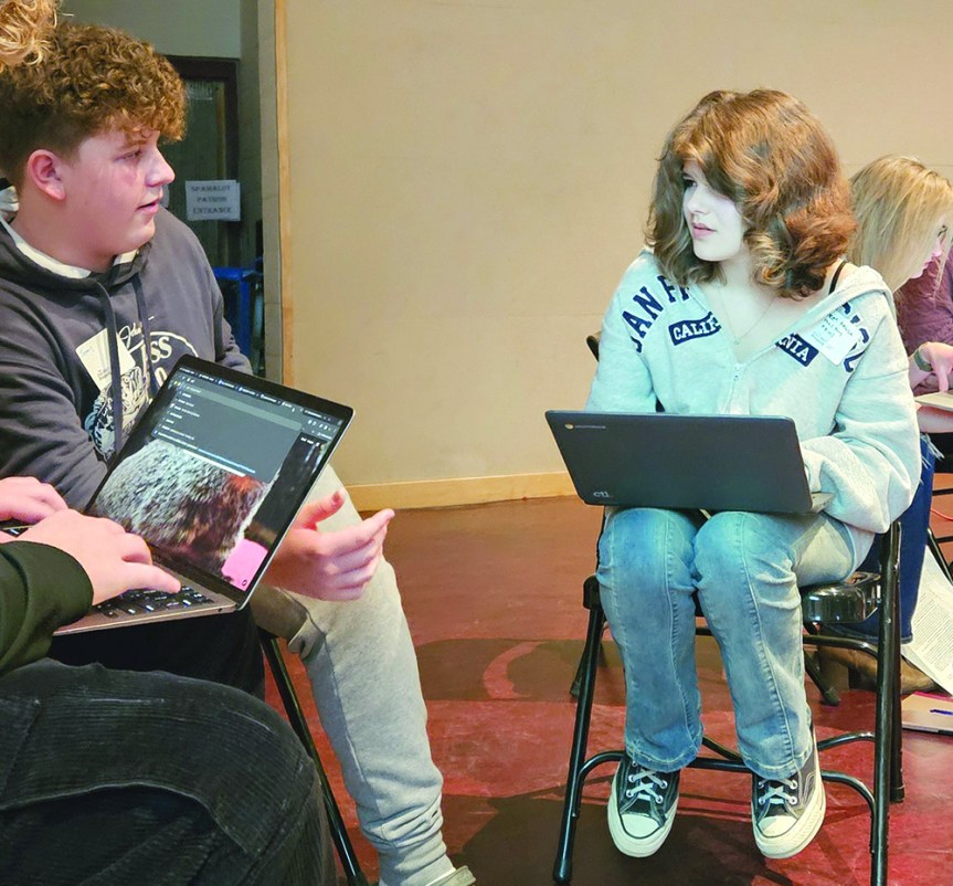 WHS freshman James Arthurs, left, and Poland Regional High senior Audrey Fryda engage in a courteous conversation regarding a current legislative issue.