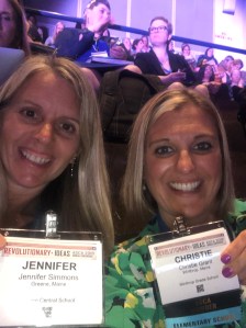 Two counselors pose together at conference with their name badges
