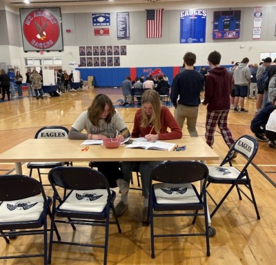 Students take a break from the interactive booths to assess their budgets. 